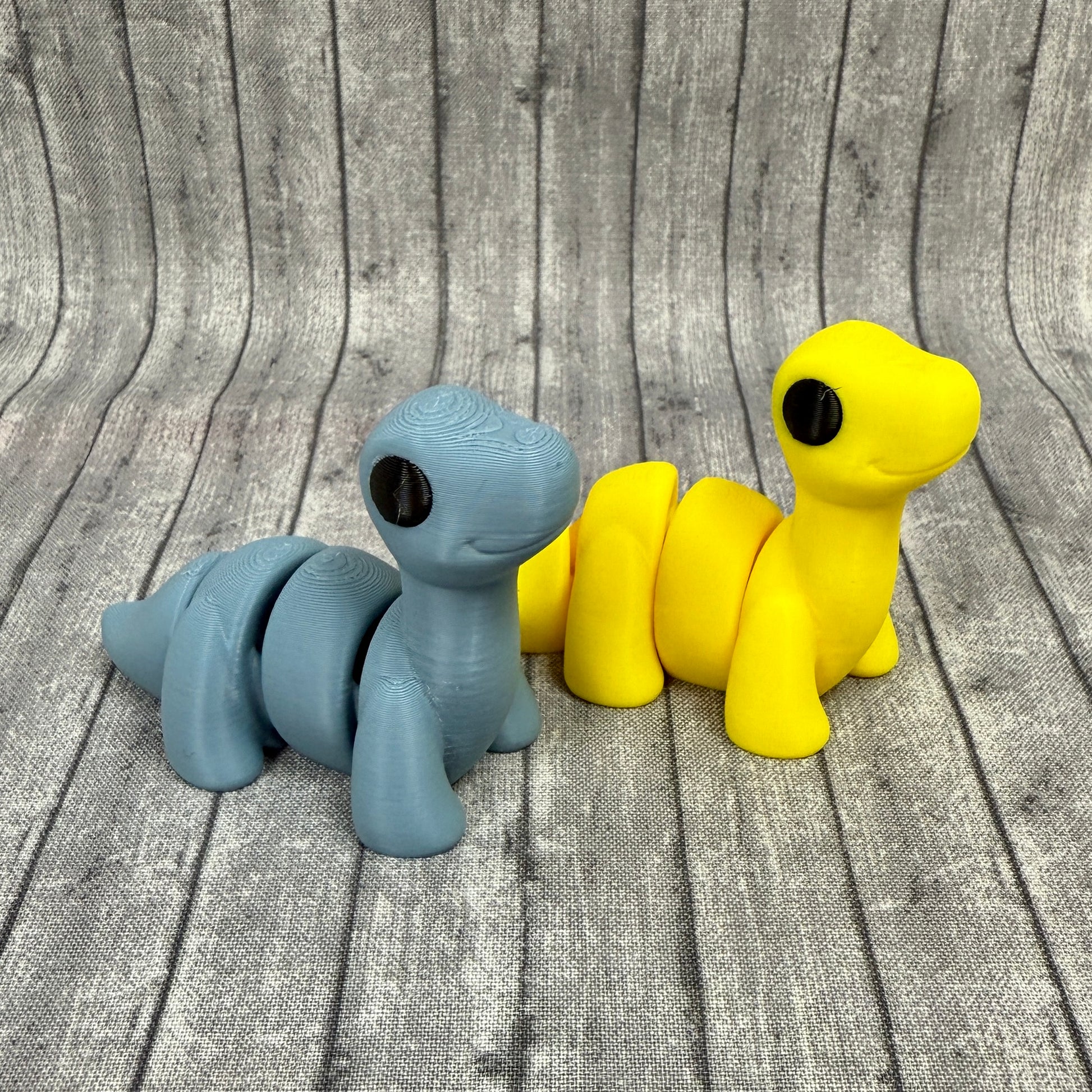 Bella and Bo brontosauruses Yellow Blue Gray Fidget Toy