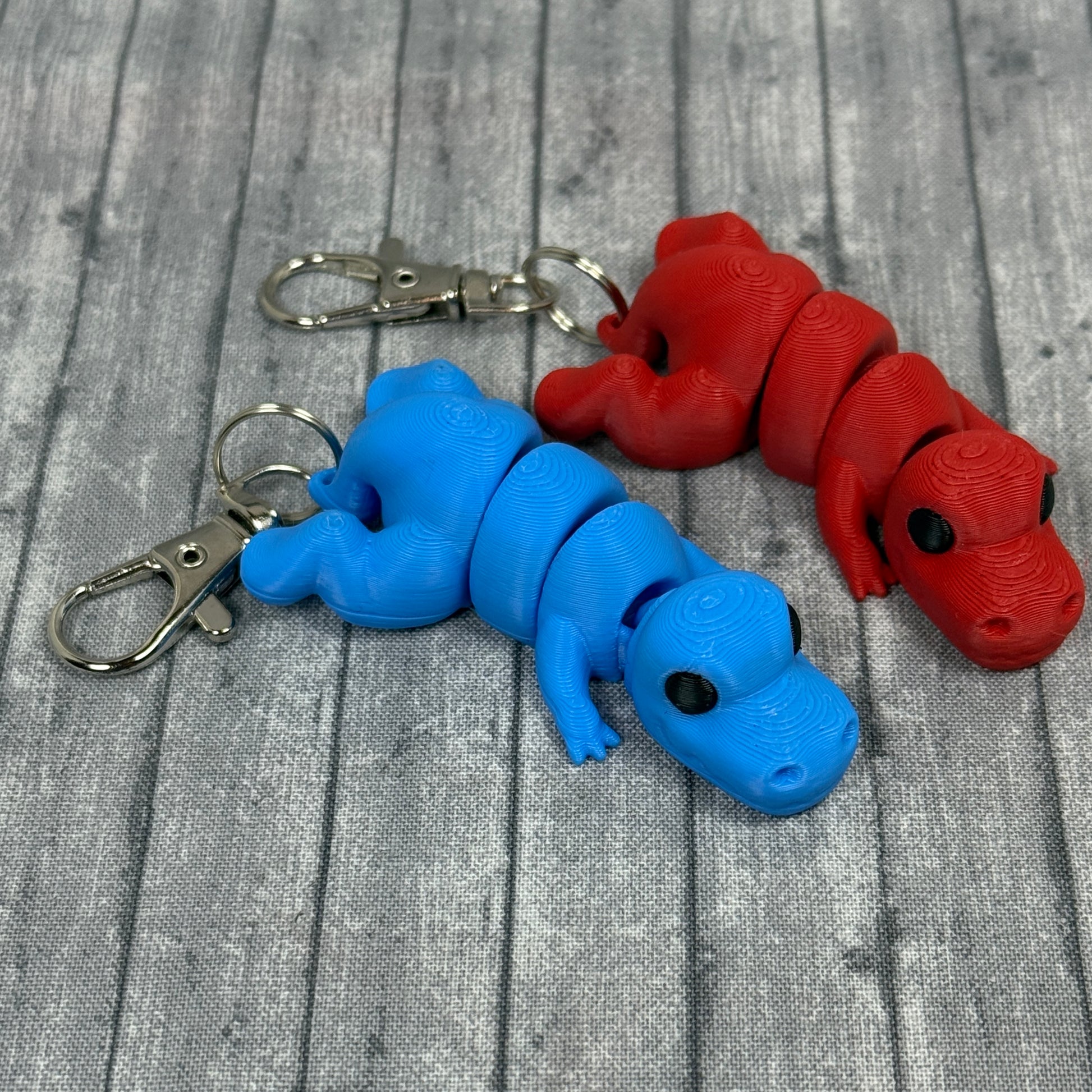 Tyra and Titan T-Rex fidget toy red blue keychain
